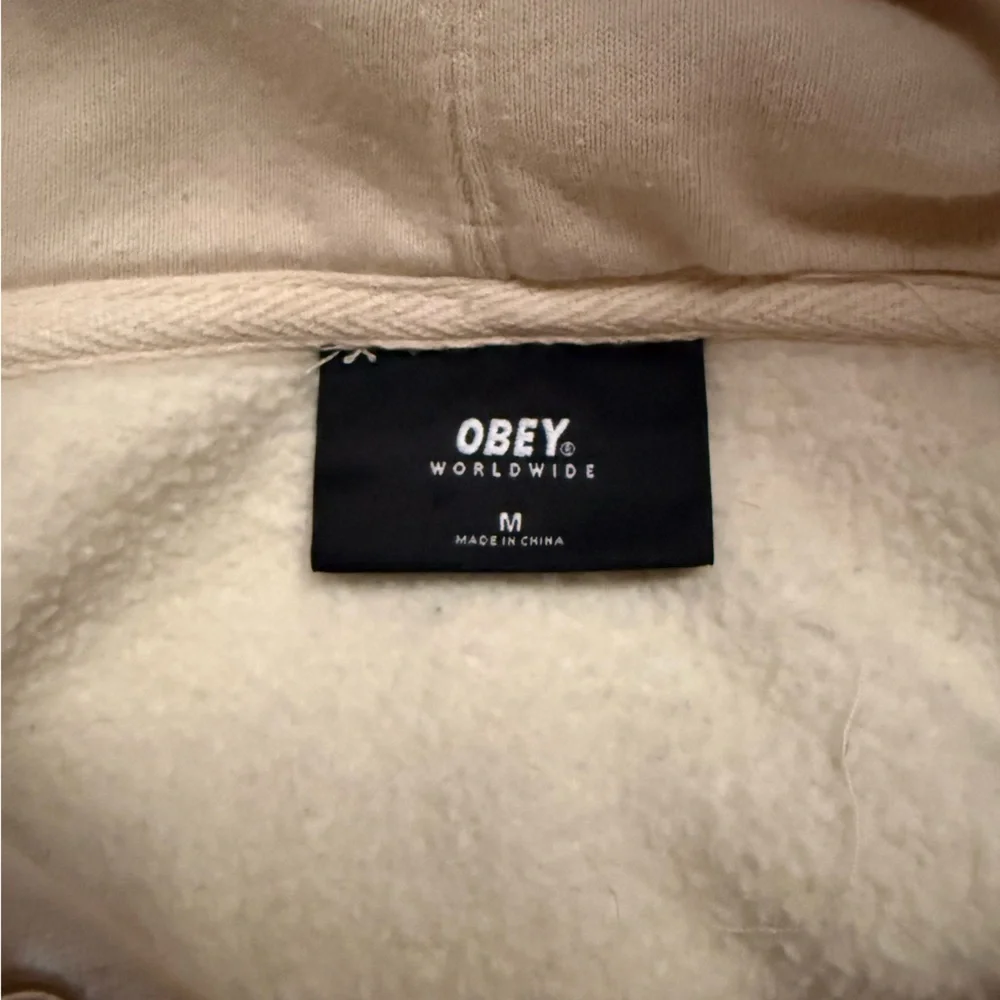 Obey Cream Hoodie with Yellow Flower Graphic